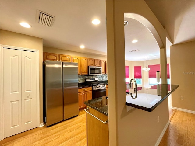 16405 SW 14th Avenue Rd, Ocala, FL 34473 - kitchen featuring stainless steel appliances, light wood-style floors, baseboards, recessed lighting, and decorative backsplash