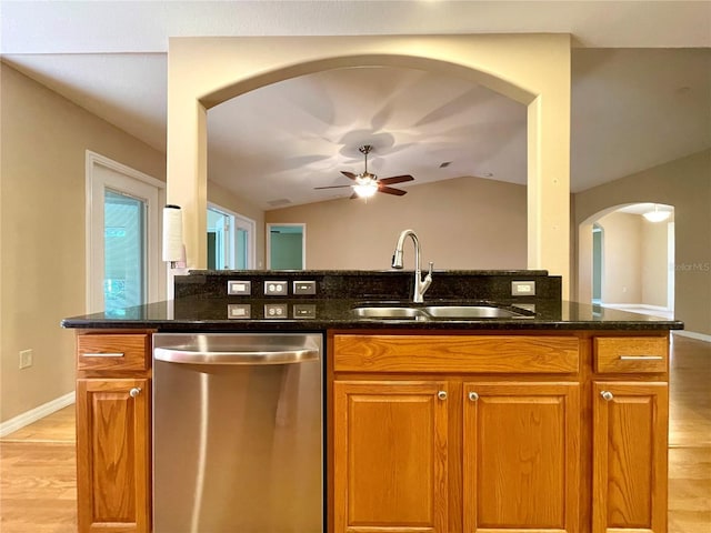 16405 SW 14th Avenue Rd, Ocala, FL 34473 - kitchen featuring stainless steel dishwasher, a sink, arched walkways, light wood-style flooring, and ceiling fan
