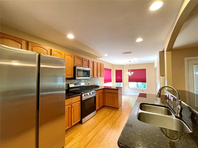 16405 SW 14th Avenue Rd, Ocala, FL 34473 - kitchen featuring stainless steel appliances, a sink, light wood-type flooring, backsplash, and recessed lighting