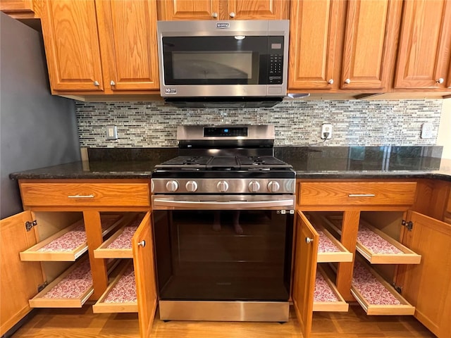 16405 SW 14th Avenue Rd, Ocala, FL 34473 - kitchen with appliances with stainless steel finishes, decorative backsplash, wood finished floors, and brown cabinetry