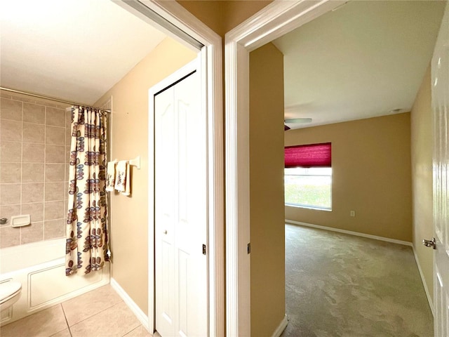 16405 SW 14th Avenue Rd, Ocala, FL 34473 - bathroom with shower / bath combo, toilet, baseboards, a ceiling fan, and tile patterned floors