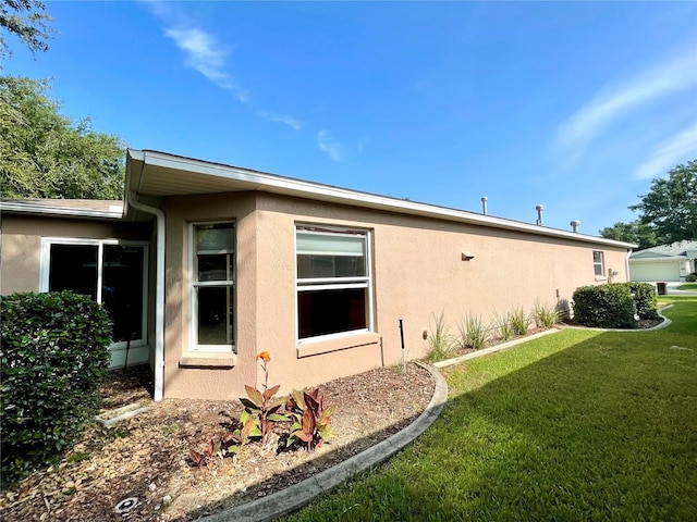 16405 SW 14th Avenue Rd, Ocala, FL 34473 - view of property exterior with stucco siding and a yard