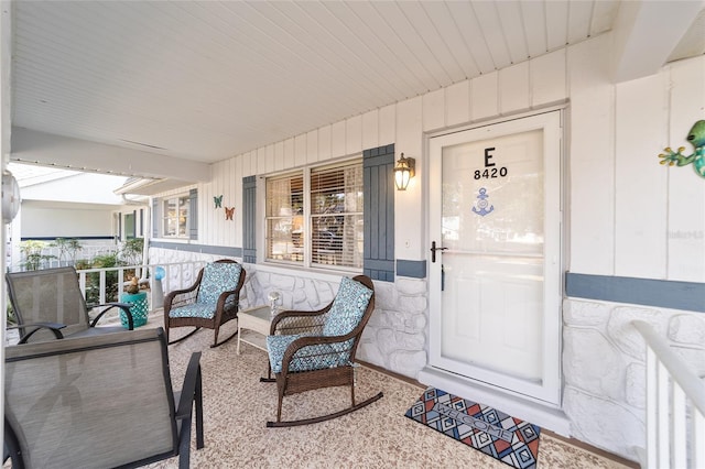 8420 SW 93rd Ln Unit E, Ocala, FL 34476 - entrance to property featuring a porch, board and batten siding, and stone siding