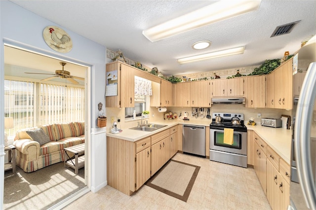 8420 SW 93rd Ln Unit E, Ocala, FL 34476 - kitchen featuring stainless steel appliances, under cabinet range hood, a sink, light brown cabinets, and light countertops