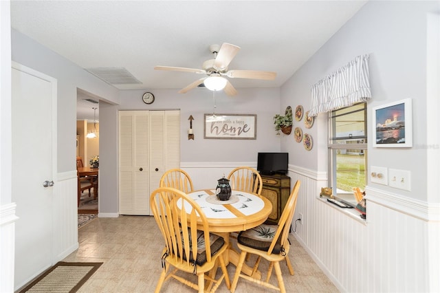 8420 SW 93rd Ln Unit E, Ocala, FL 34476 - dining area featuring a wainscoted wall and a ceiling fan