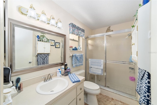 8420 SW 93rd Ln Unit E, Ocala, FL 34476 - full bathroom featuring toilet, vanity, a shower stall, and a textured ceiling