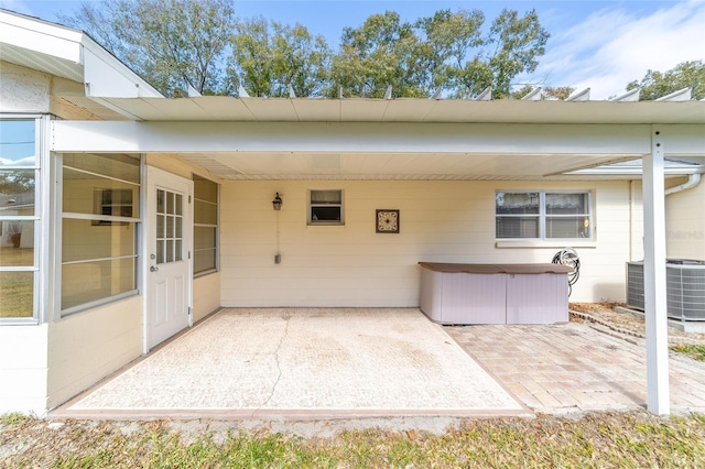 8420 SW 93rd Ln Unit E, Ocala, FL 34476 - view of patio with central air condition unit, a jacuzzi, and a carport