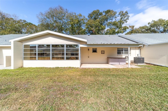 8420 SW 93rd Ln Unit E, Ocala, FL 34476 - back of house featuring central air condition unit, a patio area, a lawn, and a shingled roof
