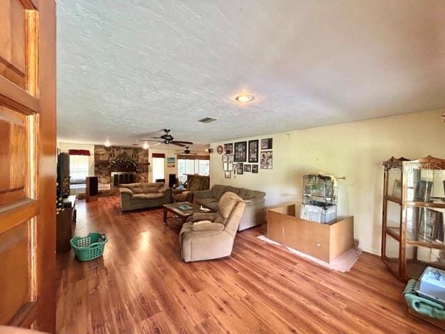 20100 SW 95th St, Dunnellon, FL 34431 - living room with wood finished floors, ceiling fan, and a fireplace