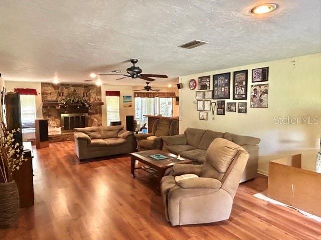 20100 SW 95th St, Dunnellon, FL 34431 - living room featuring a textured ceiling, a ceiling fan, and wood finished floors