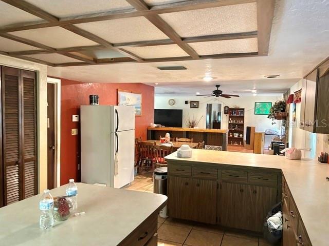 20100 SW 95th St, Dunnellon, FL 34431 - kitchen featuring freestanding refrigerator, light countertops, a peninsula, coffered ceiling, and a ceiling fan