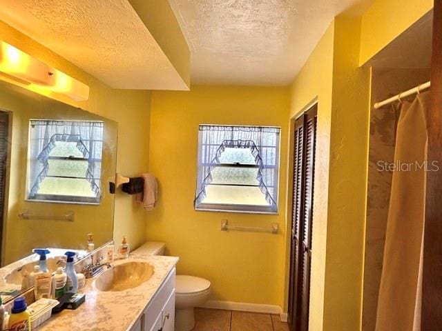 20100 SW 95th St, Dunnellon, FL 34431 - full bathroom with a textured ceiling, toilet, vanity, tile patterned flooring, and a shower with shower curtain