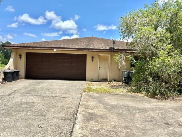 20100 SW 95th St, Dunnellon, FL 34431 - single story home featuring stucco siding, central air condition unit, an attached garage, and concrete driveway