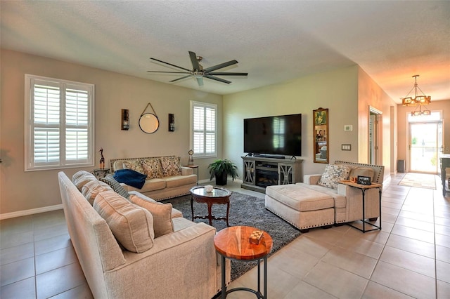 6405 SW 88th Loop, Ocala, FL 34476 - living area with light tile patterned flooring, a ceiling fan, and a chandelier