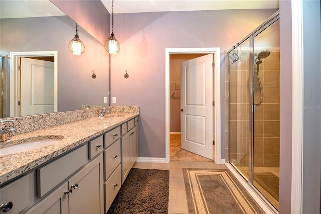 6405 SW 88th Loop, Ocala, FL 34476 - bathroom featuring a stall shower, double vanity, tile patterned flooring, and a walk in closet