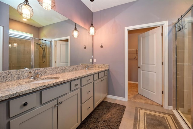 6405 SW 88th Loop, Ocala, FL 34476 - bathroom featuring double vanity, a tile shower, a spacious closet, and tile patterned flooring