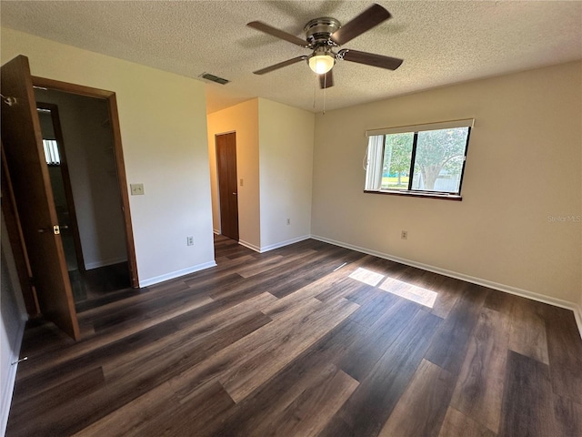 10080 SW 97th Ct, Ocala, FL 34481 - unfurnished bedroom with a textured ceiling, dark wood finished floors, baseboards, and a ceiling fan