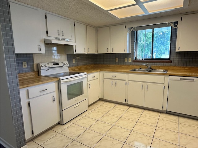 10080 SW 97th Ct, Ocala, FL 34481 - kitchen with white appliances, under cabinet range hood, a sink, backsplash, and light tile patterned floors