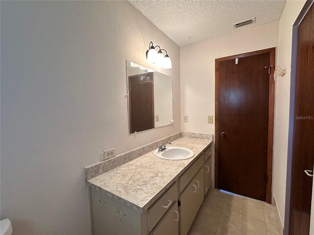 10080 SW 97th Ct, Ocala, FL 34481 - bathroom featuring a textured ceiling, vanity, and a textured wall