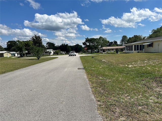 10080 SW 97th Ct, Ocala, FL 34481 - view of asphalt road featuring traffic signs