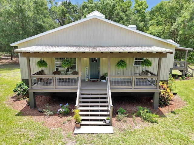 12080 SE Sunset Harbor Rd, Weirsdale, FL 32195 - view of front of home with stairway, a metal roof, and covered porch