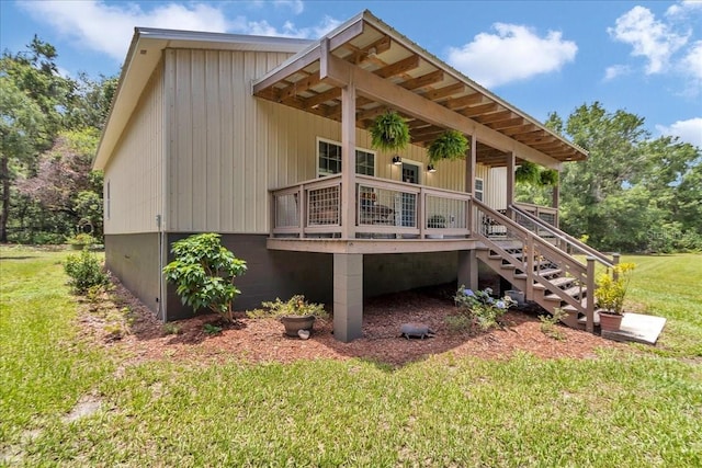 12080 SE Sunset Harbor Rd, Weirsdale, FL 32195 - back of house featuring a lawn, a wooden deck, and stairway