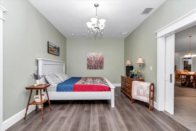 12080 SE Sunset Harbor Rd, Weirsdale, FL 32195 - bedroom with a chandelier and wood finished floors