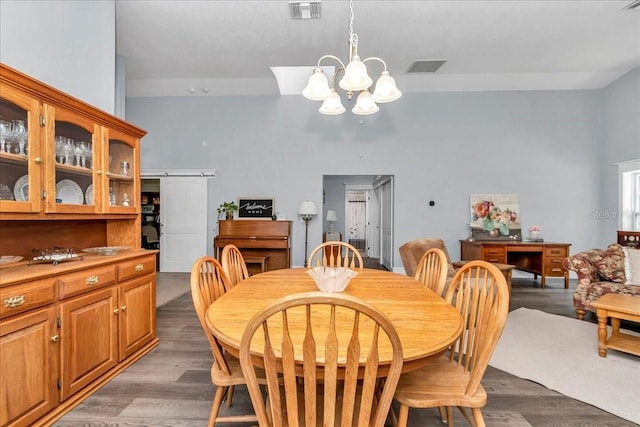 12080 SE Sunset Harbor Rd, Weirsdale, FL 32195 - dining area with a chandelier, light wood-style floors, and a towering ceiling
