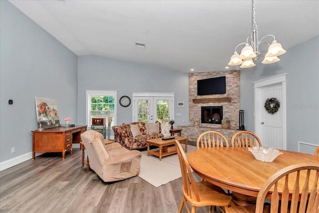 12080 SE Sunset Harbor Rd, Weirsdale, FL 32195 - living area with light wood finished floors, a fireplace, a chandelier, recessed lighting, and vaulted ceiling