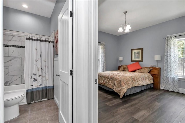 12080 SE Sunset Harbor Rd, Weirsdale, FL 32195 - bedroom featuring a chandelier and wood finished floors
