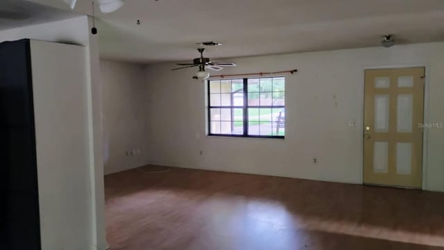 8485 E Hampton Point Rd, Inverness, FL 34450 - empty room with a ceiling fan and wood finished floors
