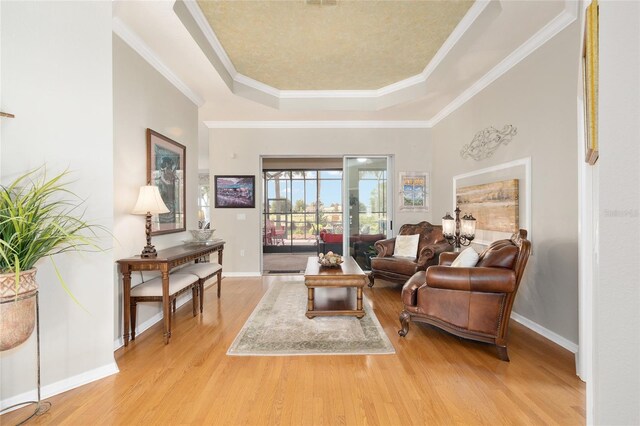 8737 SW 83rd Cir, Ocala, FL 34481 - living area with a raised ceiling, light wood-style floors, baseboards, and ornamental molding