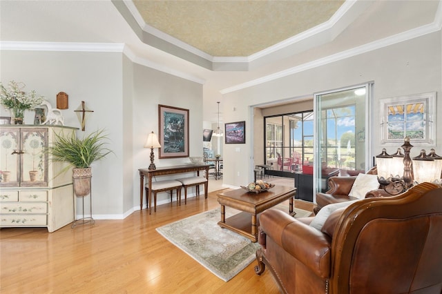 8737 SW 83rd Cir, Ocala, FL 34481 - living room featuring light wood-style floors, crown molding, a tray ceiling, and baseboards
