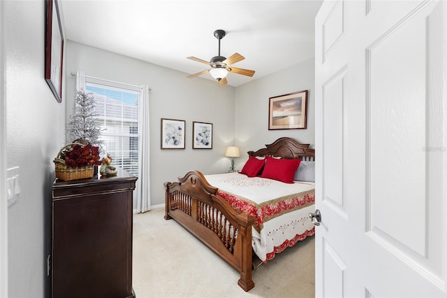8737 SW 83rd Cir, Ocala, FL 34481 - bedroom with light colored carpet, a ceiling fan, and baseboards