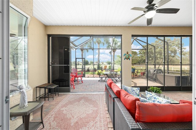 8737 SW 83rd Cir, Ocala, FL 34481 - sunroom featuring ceiling fan and outdoor lounge area