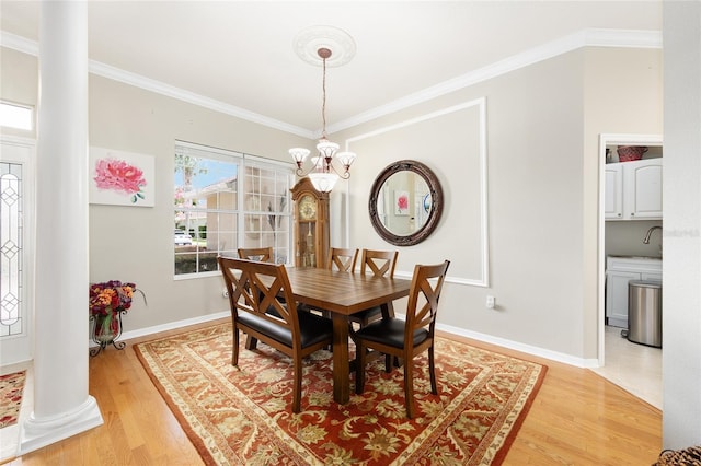 8737 SW 83rd Cir, Ocala, FL 34481 - dining space featuring decorative columns, a chandelier, light wood-style flooring, ornamental molding, and baseboards
