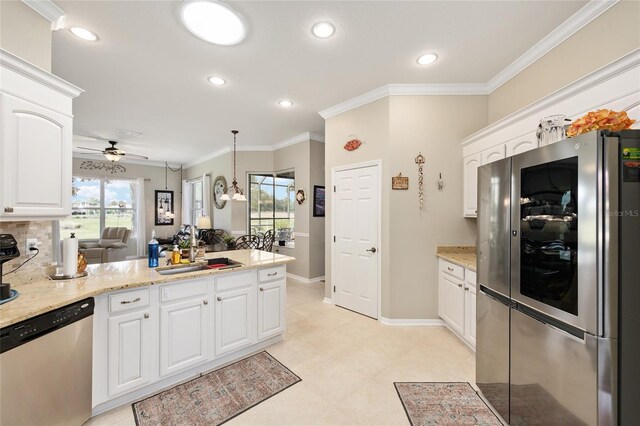 8737 SW 83rd Cir, Ocala, FL 34481 - kitchen with stainless steel appliances, ceiling fan, a sink, a peninsula, and white cabinets