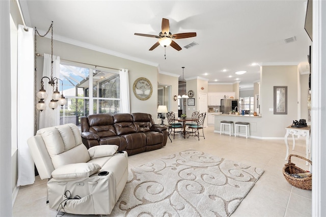 8737 SW 83rd Cir, Ocala, FL 34481 - living area featuring ornamental molding, light tile patterned flooring, a ceiling fan, healthy amount of natural light, and baseboards
