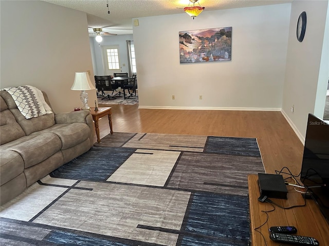 8801 SW 92nd St Unit B, Ocala, FL 34481 - living area featuring wood finished floors, a ceiling fan, baseboards, and a textured ceiling