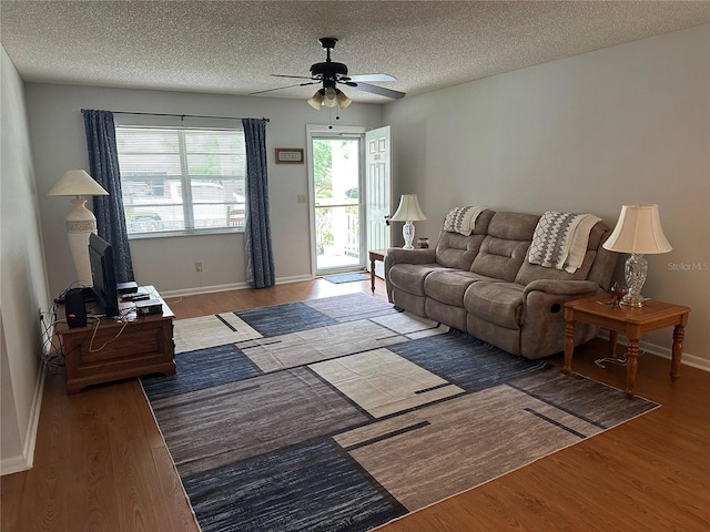 8801 SW 92nd St Unit B, Ocala, FL 34481 - living area featuring ceiling fan, wood finished floors, a textured ceiling, and baseboards