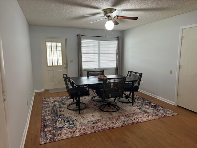 8801 SW 92nd St Unit B, Ocala, FL 34481 - dining space with wood finished floors, a ceiling fan, a textured ceiling, and baseboards