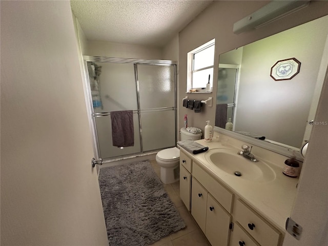8801 SW 92nd St Unit B, Ocala, FL 34481 - full bathroom with toilet, a textured ceiling, a stall shower, vanity, and tile patterned floors