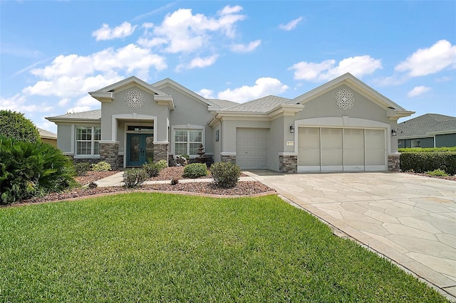 8772 SE 130th Loop, Summerfield, FL 34491 - view of front of house featuring stucco siding, stone siding, an attached garage, concrete driveway, and a front lawn