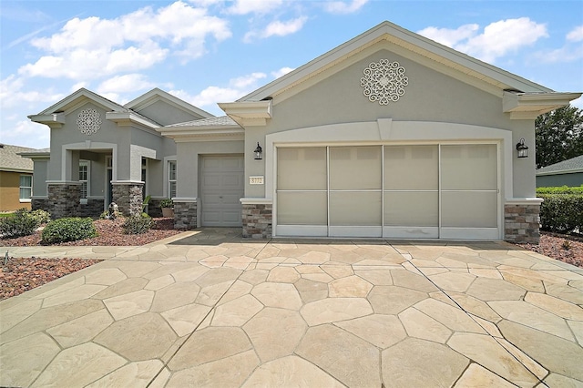 8772 SE 130th Loop, Summerfield, FL 34491 - view of front facade with stone siding, stucco siding, an attached garage, and driveway