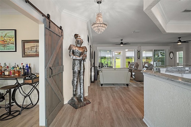 8772 SE 130th Loop, Summerfield, FL 34491 - hallway with a barn door, ornamental molding, light wood-style flooring, a chandelier, and baseboards