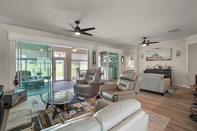 8772 SE 130th Loop, Summerfield, FL 34491 - living room featuring a ceiling fan, crown molding, wood finished floors, and a textured ceiling