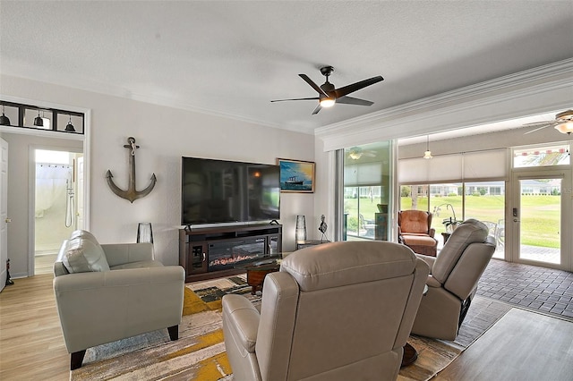 8772 SE 130th Loop, Summerfield, FL 34491 - living room featuring ceiling fan, crown molding, a textured ceiling, and wood finished floors