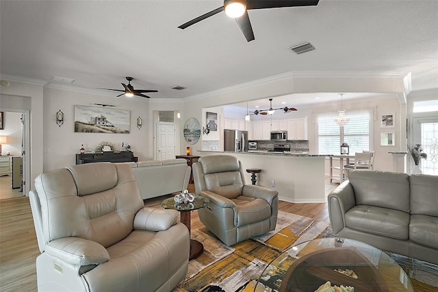 8772 SE 130th Loop, Summerfield, FL 34491 - living area with a ceiling fan, light wood-type flooring, ornamental molding, and a chandelier