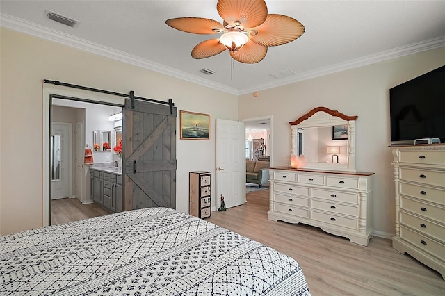 8772 SE 130th Loop, Summerfield, FL 34491 - bedroom featuring light wood-type flooring, crown molding, a barn door, ensuite bathroom, and ceiling fan