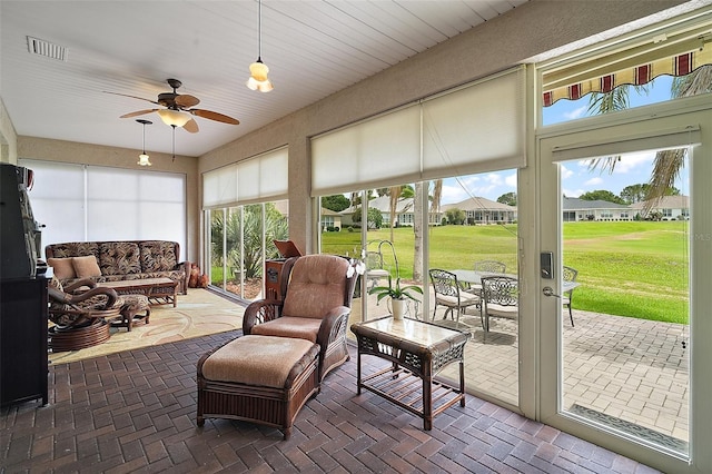 8772 SE 130th Loop, Summerfield, FL 34491 - sunroom / solarium featuring a ceiling fan, an outdoor hangout area, and healthy amount of natural light